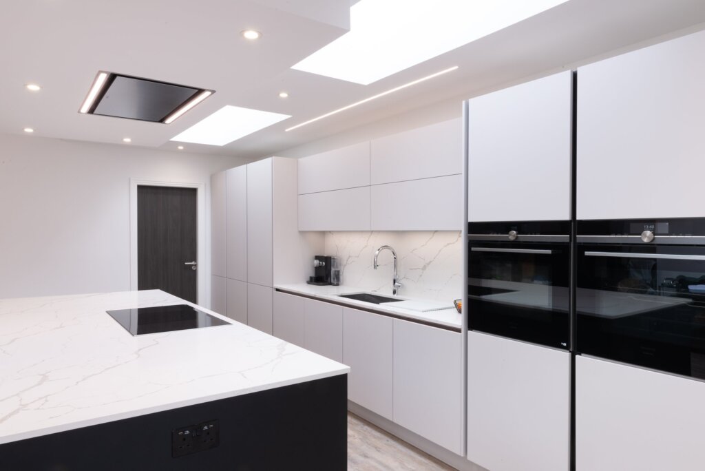 Signature white matt kitchen with marble splashback and integrated Siemens ovens