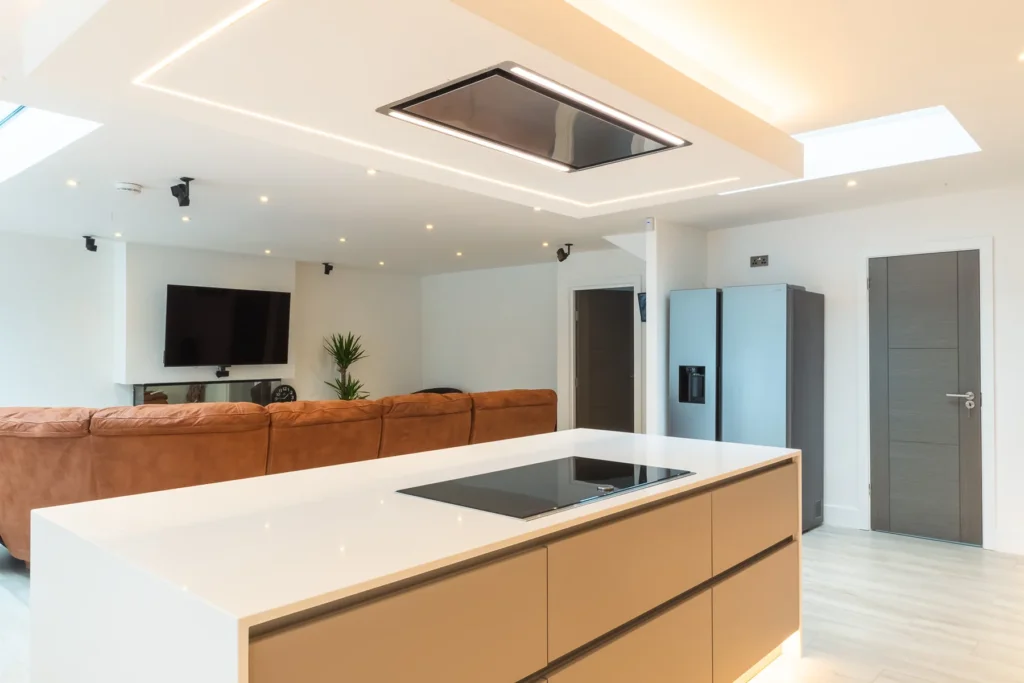 Cappuccino gloss handleless kitchen with dove grey island and white quartz worktops