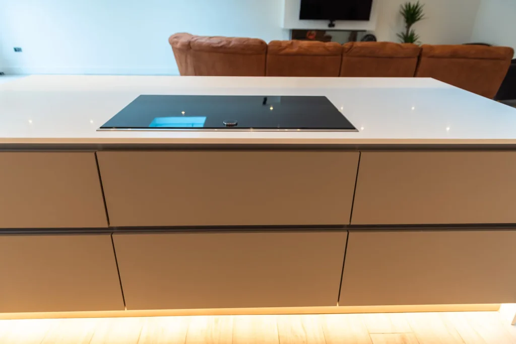 Cappuccino gloss handleless kitchen with dove grey island and white quartz worktops