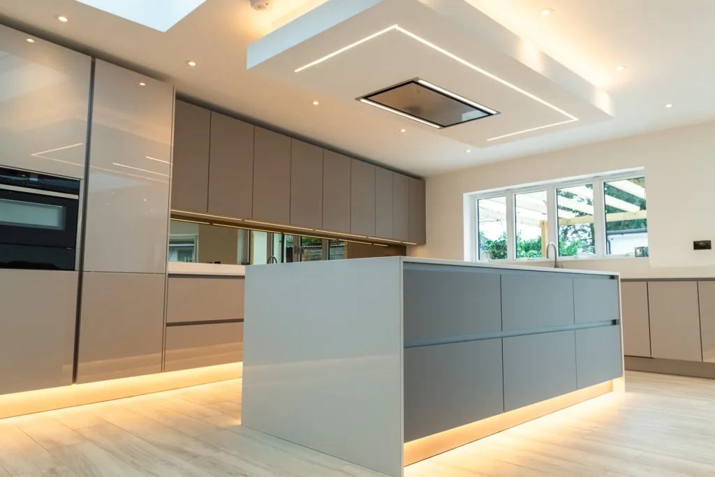 Cappuccino gloss handleless kitchen with mirrored splashback and integrated Samsung ovens