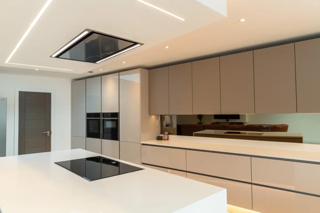 Cappuccino gloss handleless kitchen with mirrored splashback and integrated Samsung ovens