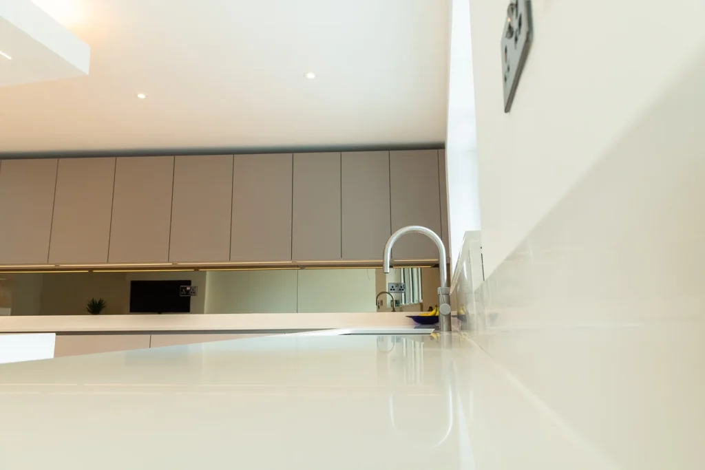 Signature cappuccino gloss kitchen with open-plan layout and mood lighting