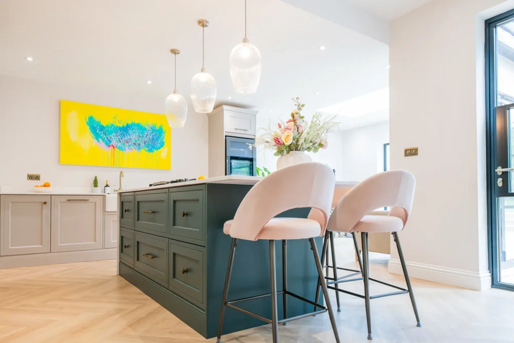 Oak veneer handleless kitchen with backlit quartzite island and marble worktops