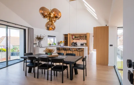White handleless kitchen with oak drinks cabinet and integrated wine store