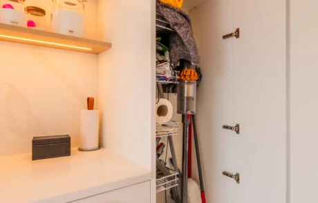 Signature white handleless kitchen with oak bi-fold pantry and coffee station