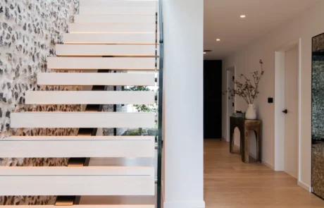 White handleless kitchen with oak drinks cabinet and integrated wine store