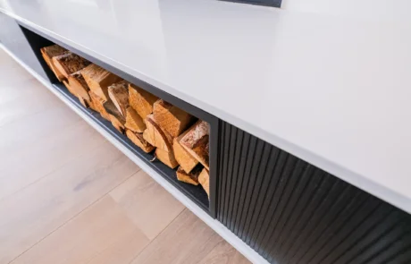 White handleless kitchen with black galley pantry and marble worktops