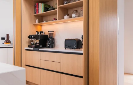 Signature white handleless kitchen with oak bi-fold pantry and coffee station