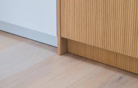 Signature white handleless kitchen with oak bi-fold pantry and coffee station