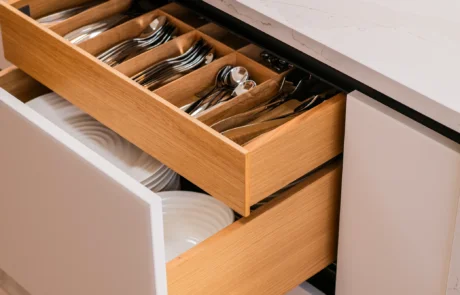 White handleless kitchen with oak drinks cabinet and integrated wine store