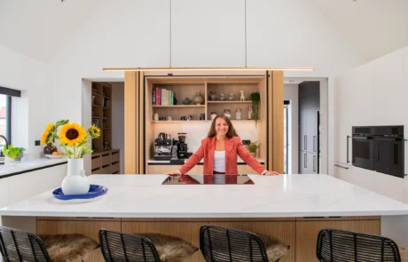 White handleless kitchen with oak drinks cabinet and integrated wine store